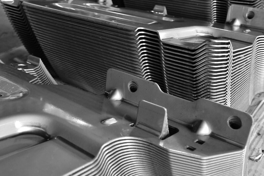 High volume steel stamping components with precision forming and progressive die stamping process