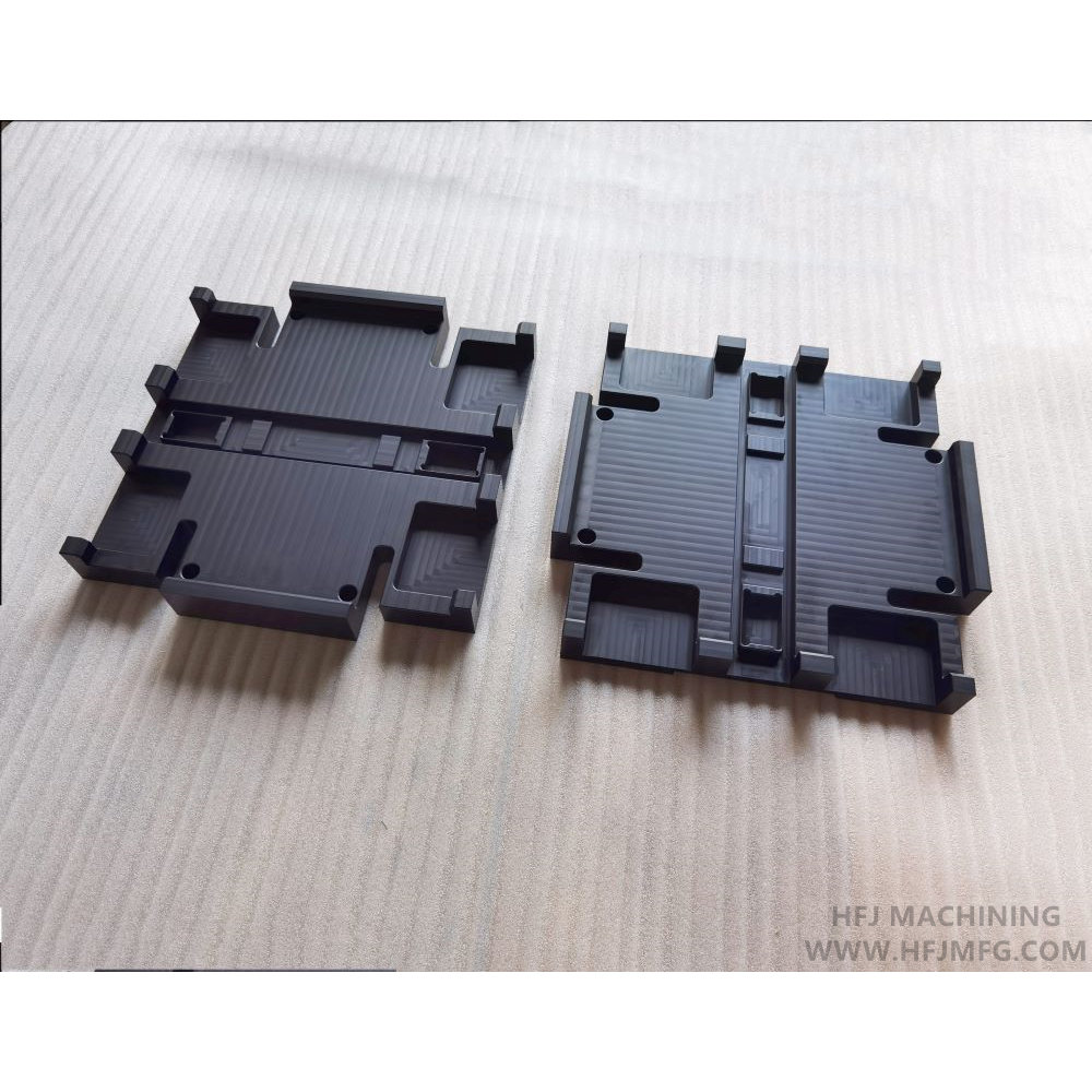 Black anodized aluminum housing with multiple pockets and slots made by CNC machining