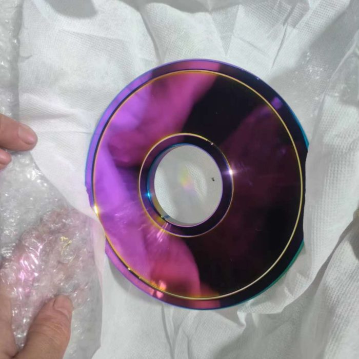 Precision machined steel weight plate with rainbow titanium plated surface finish
